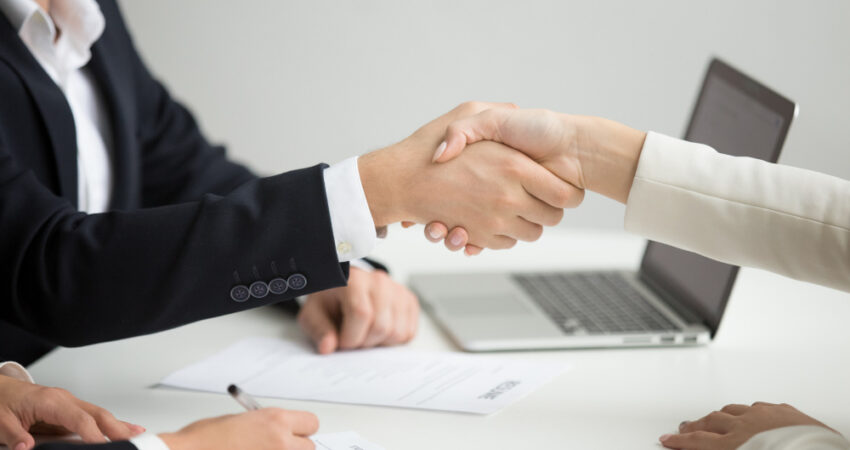 hr-handshaking-successful-candidate-getting-hired-new-job-closeup