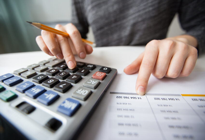 closeup-accountant-hands-counting-calculator